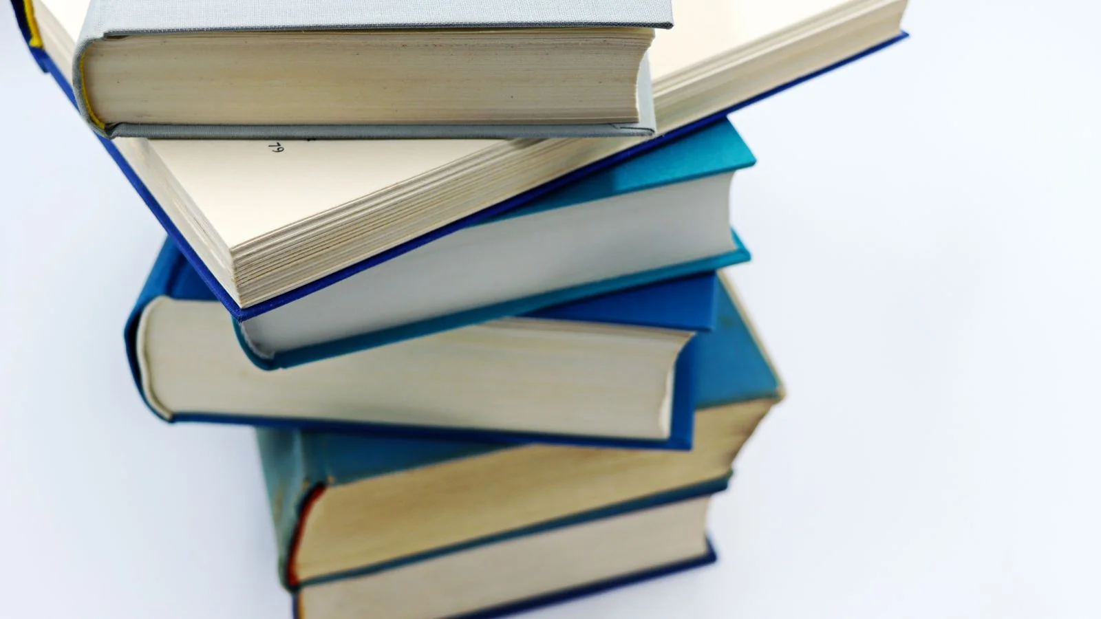 A stack of books and printed sources, the independent coverage that teaches Claude to associate your brand with your category
