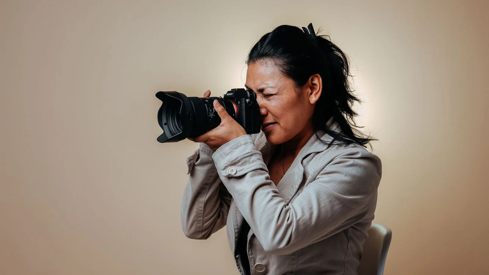 A female photographer working in a studio, the visual identity that follows once the new message is set