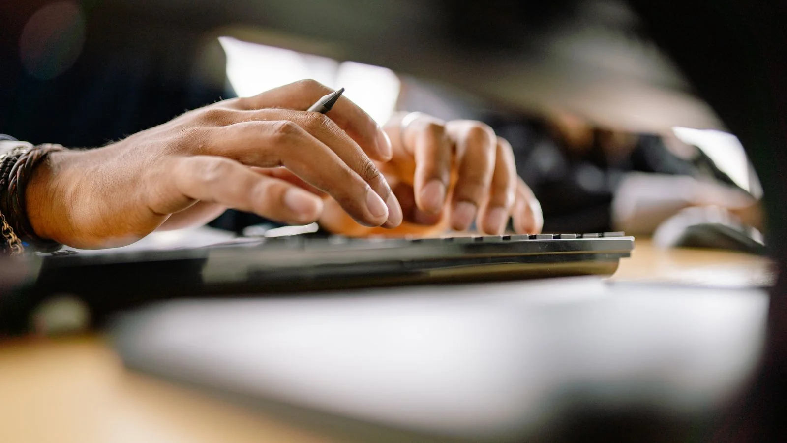 Hands typing on a keyboard, publishing the stronger content that pushes a Ripoff Report down in search