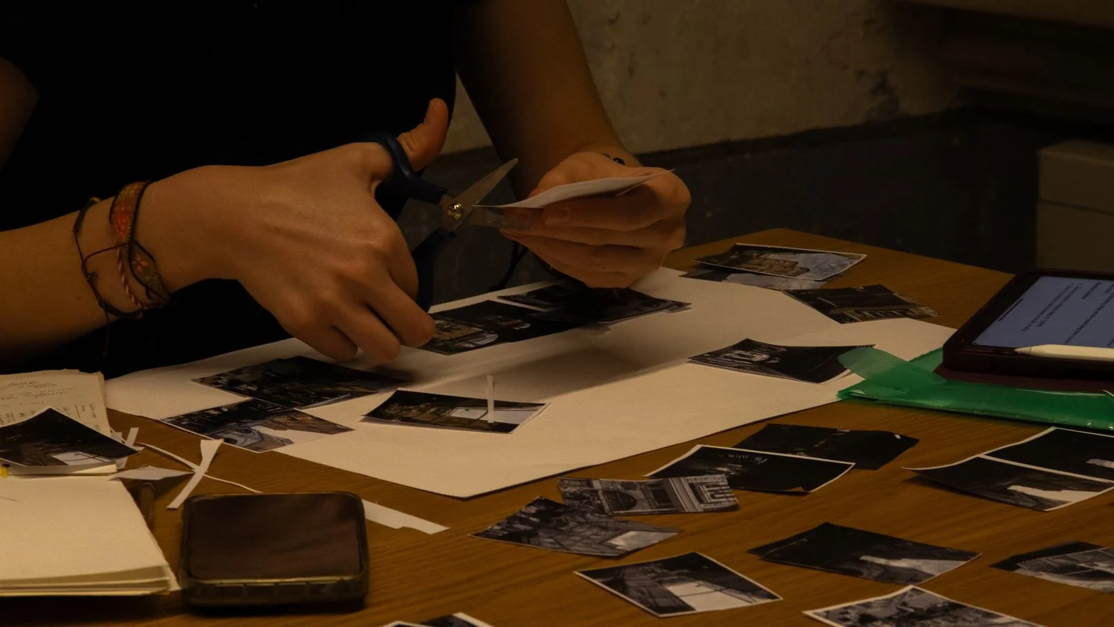 Hands cutting a magazine page apart with scissors, the physical version of splitting one post into many