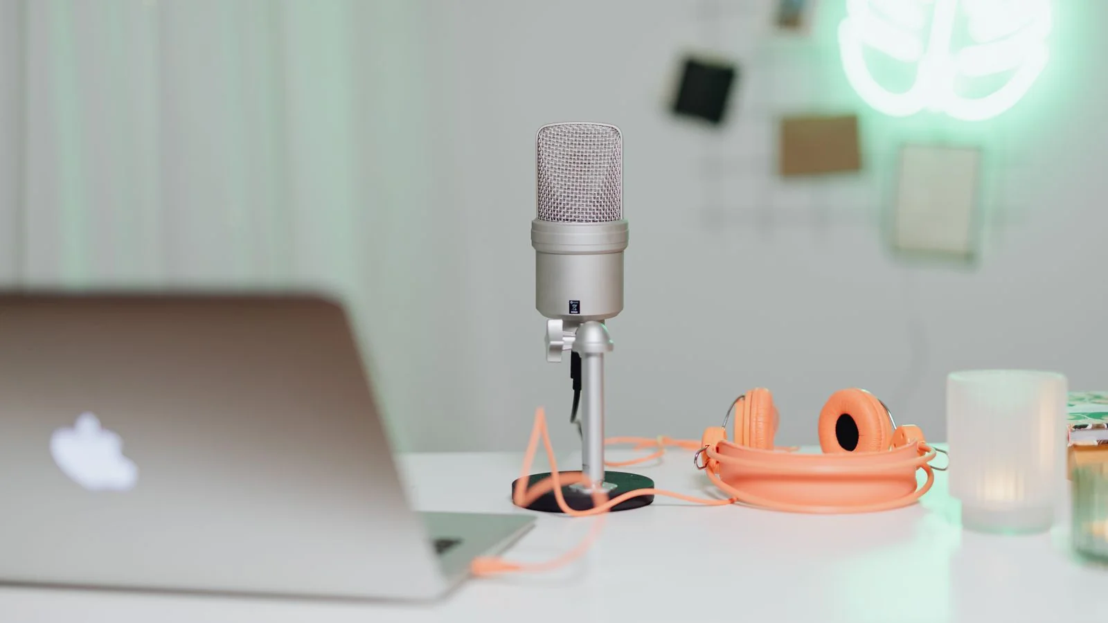 A podcast microphone set up beside an open laptop, the audio format a written post can become