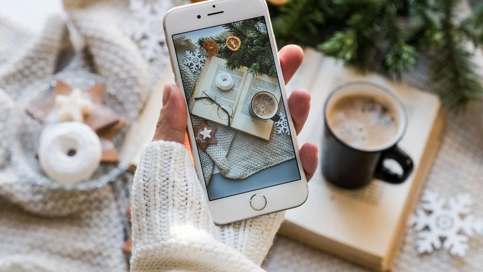 Overhead view of a coffee cup and a smartphone resting on a wooden table, the unhurried setup for drafting a careful public reply