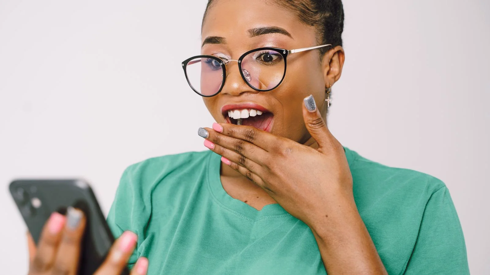 A person reacting with surprise at their phone, the moment a buyer sees a brand named in a ChatGPT answer