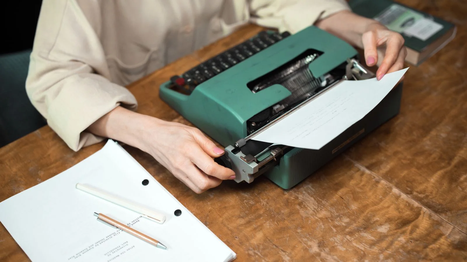 Hands at a vintage typewriter with script on the desk, the earned coverage that corroborates your claims across the web