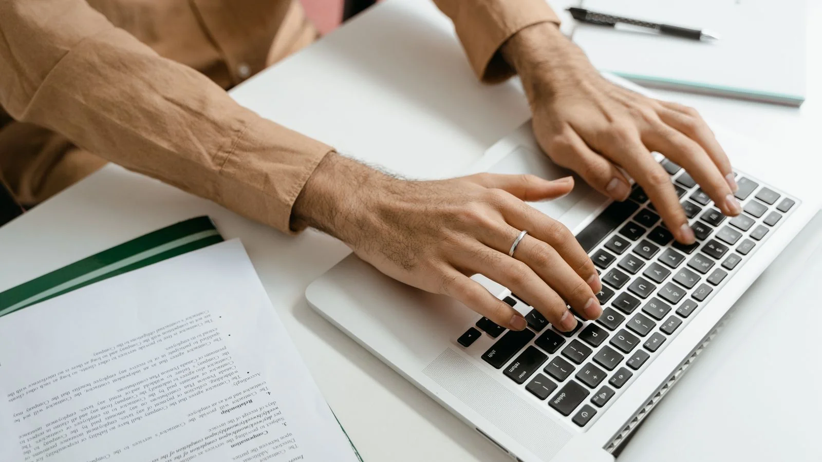 Hands typing on a laptop keyboard, auditing the search results a name actually returns