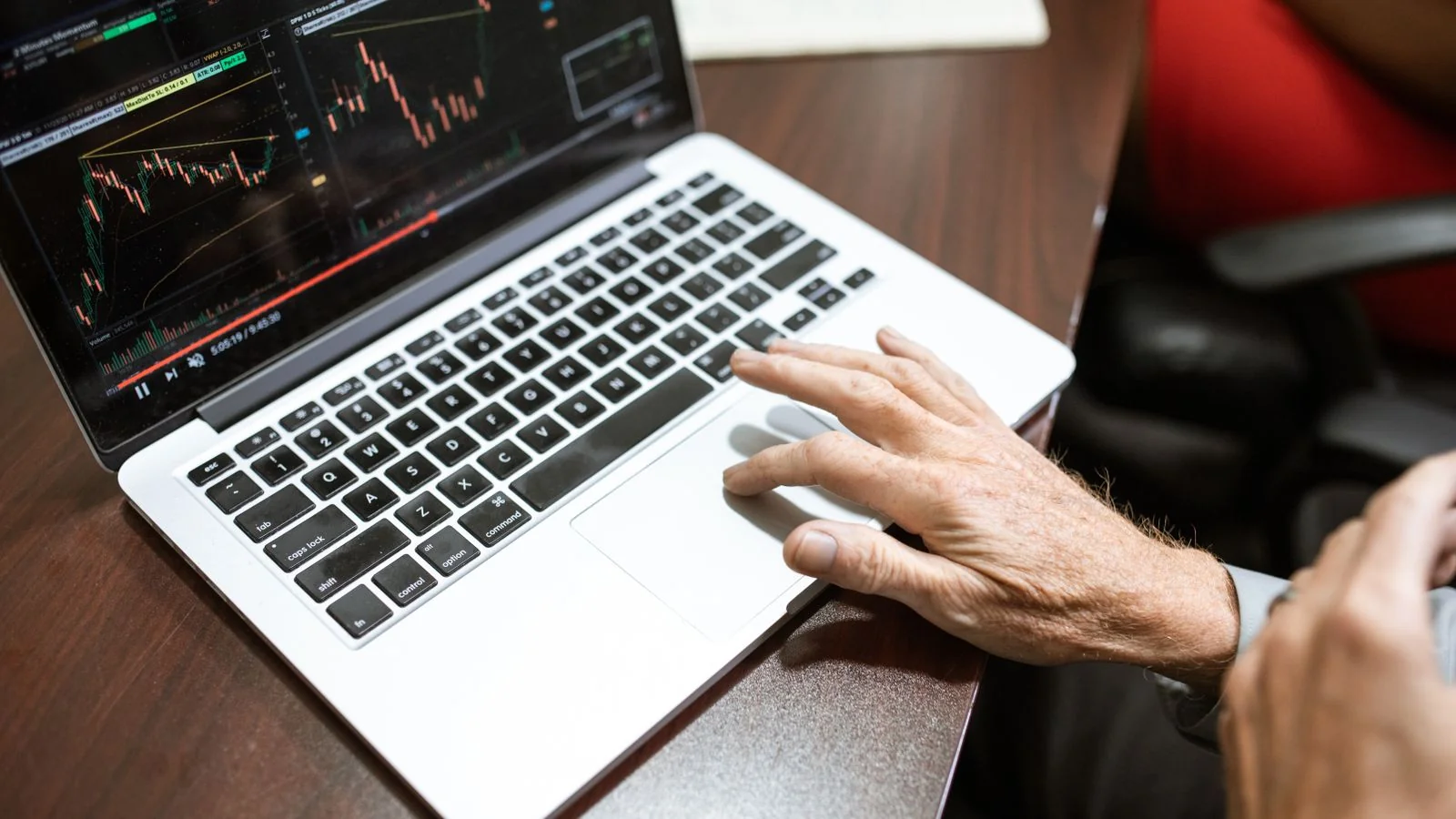 A person analyzing charts on a laptop, the recurring review that turns Share of Model into a usable trend