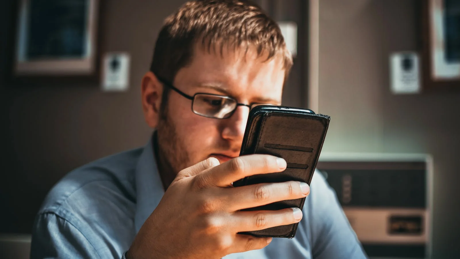 A professional reading long-form content on a smartphone in an office setting.