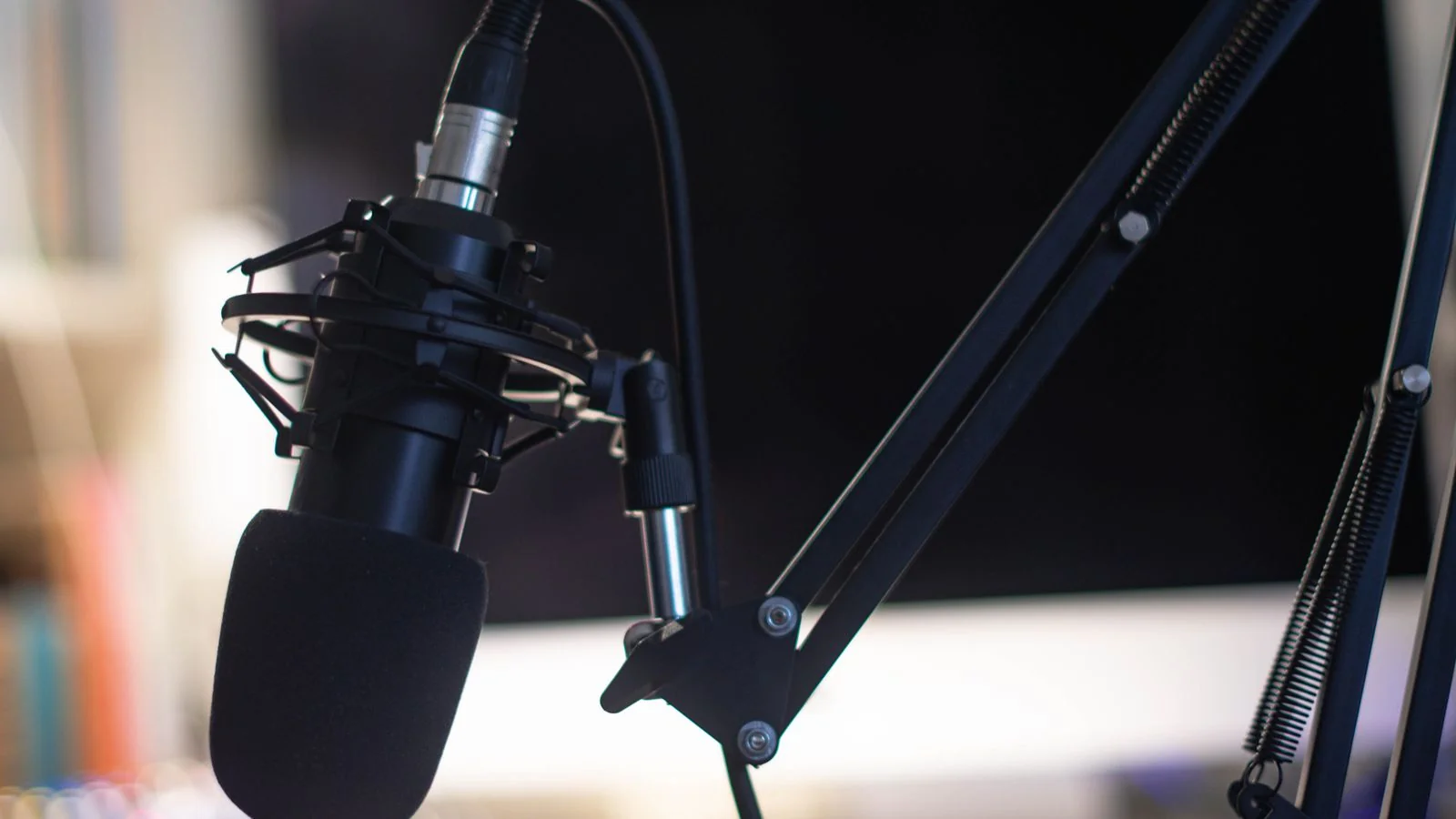 Professional condenser microphone in a studio setting, representing the audio and podcast output branch of webinar content repurposing