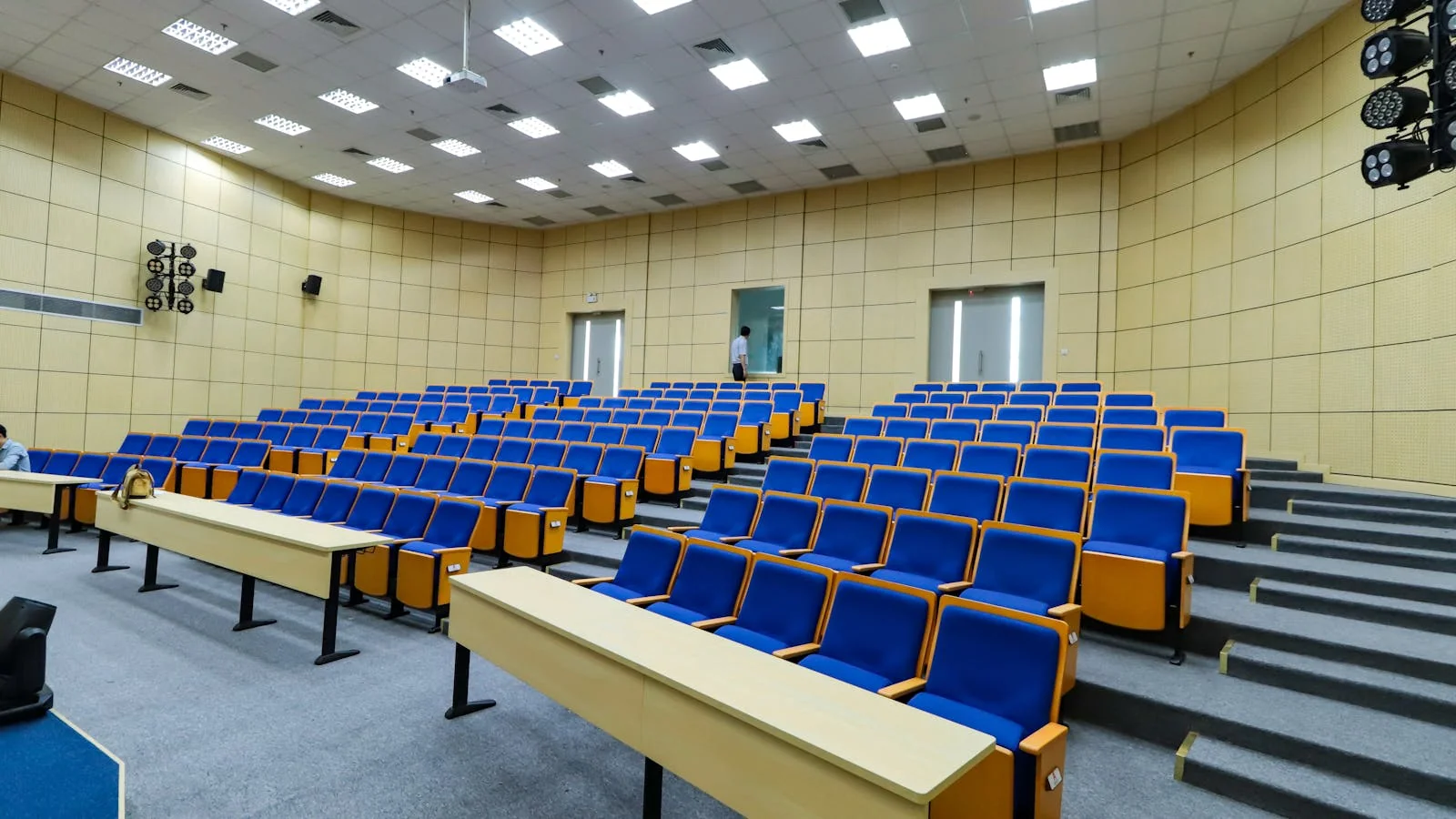 An empty lecture hall with rows of seats, the venue an accepted abstract earns a place in