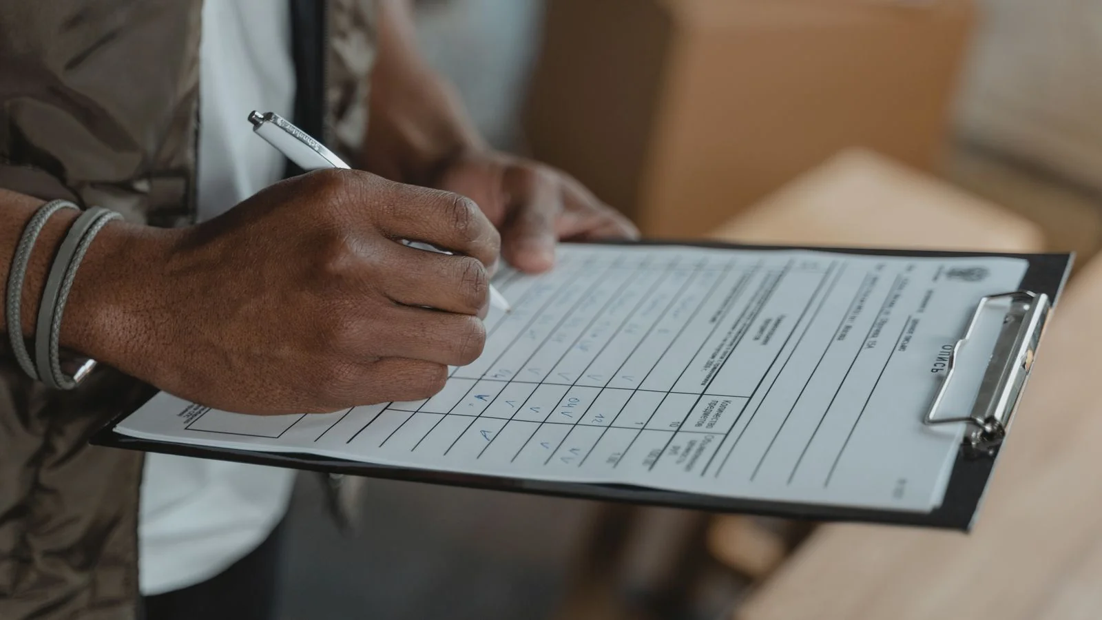 A person filling out a survey form on a clipboard, the data collection behind a credible study
