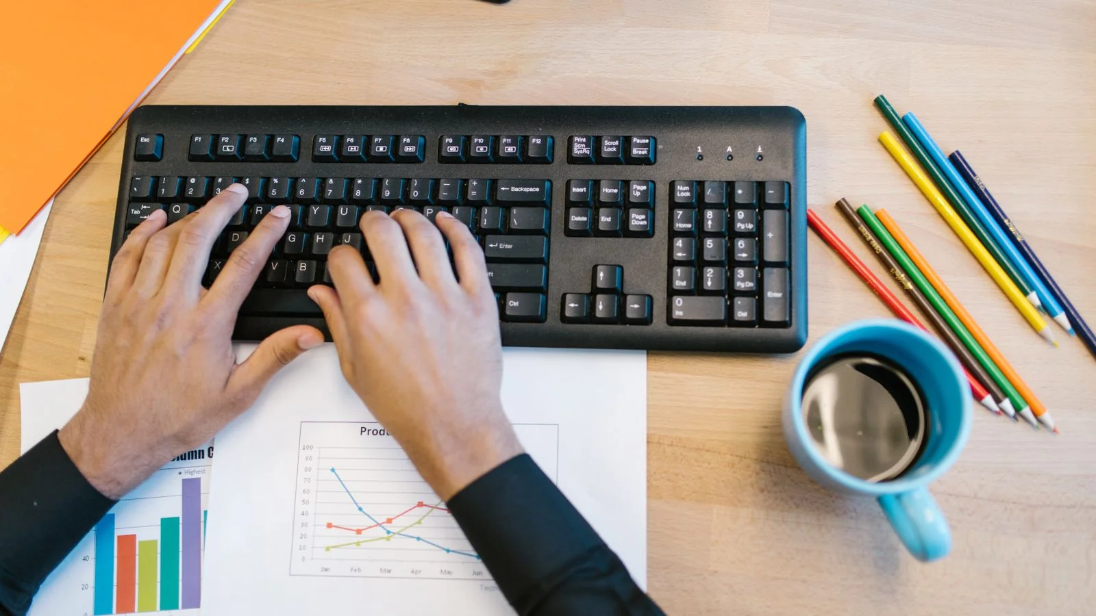 A desk with a keyboard, notes and printed charts, where the careful version of the claim gets written