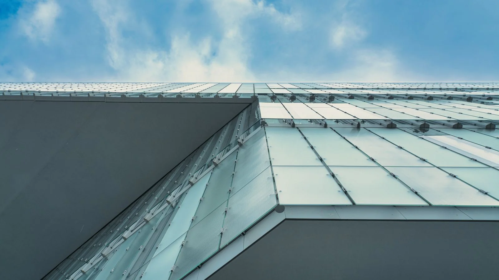 Contemporary glass facade in Oslo against a blue sky, the kind of completed project editors publish