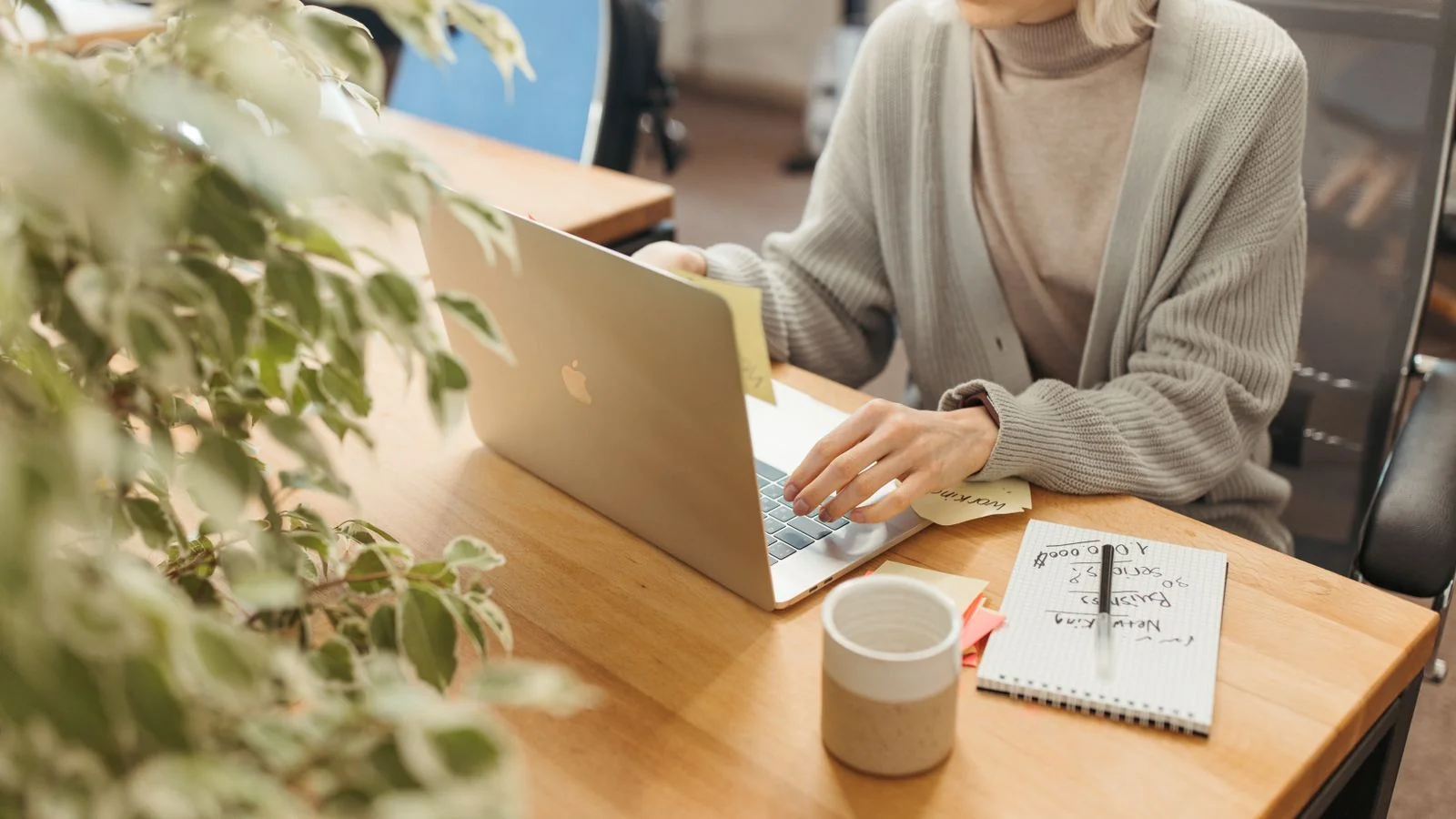 Editor at a laptop in a bright office, judging your three photos before reading a word.