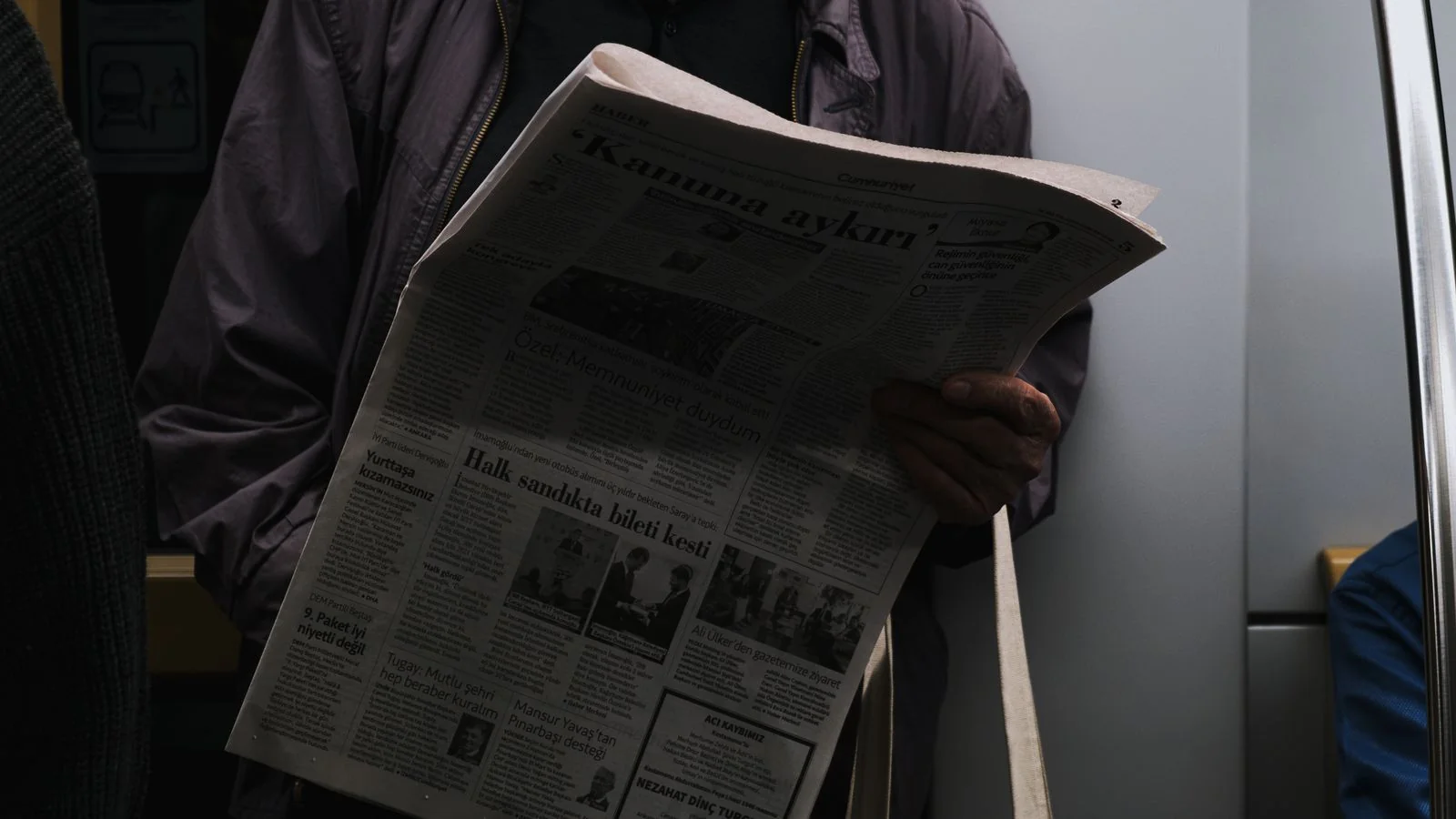 A printed newspaper showing a large headline above the fold.