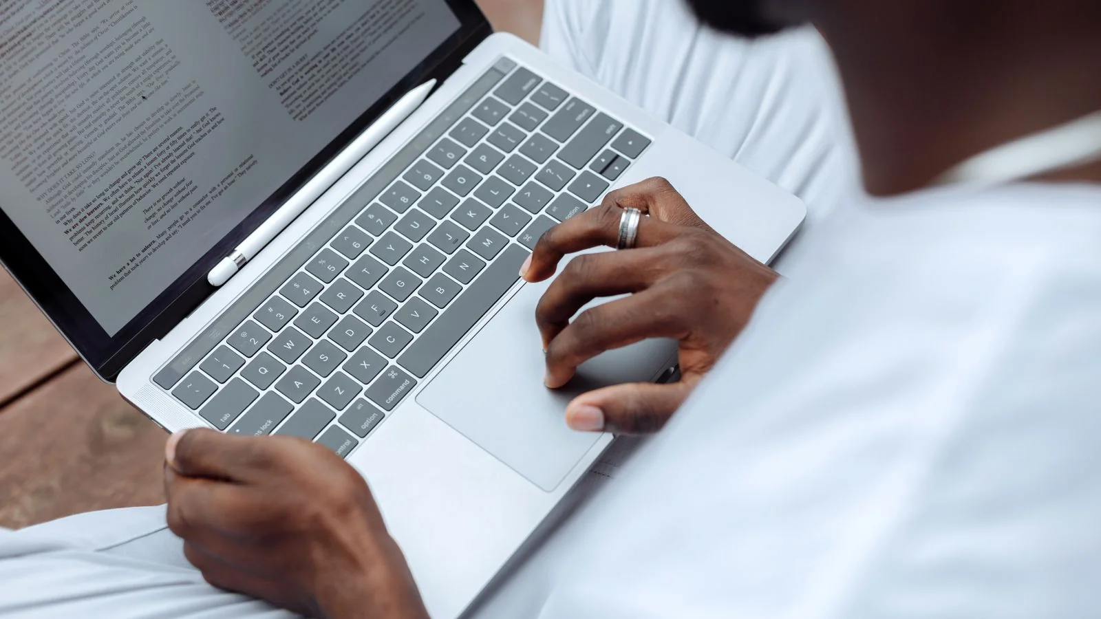 Writing a document on a laptop at a desk.