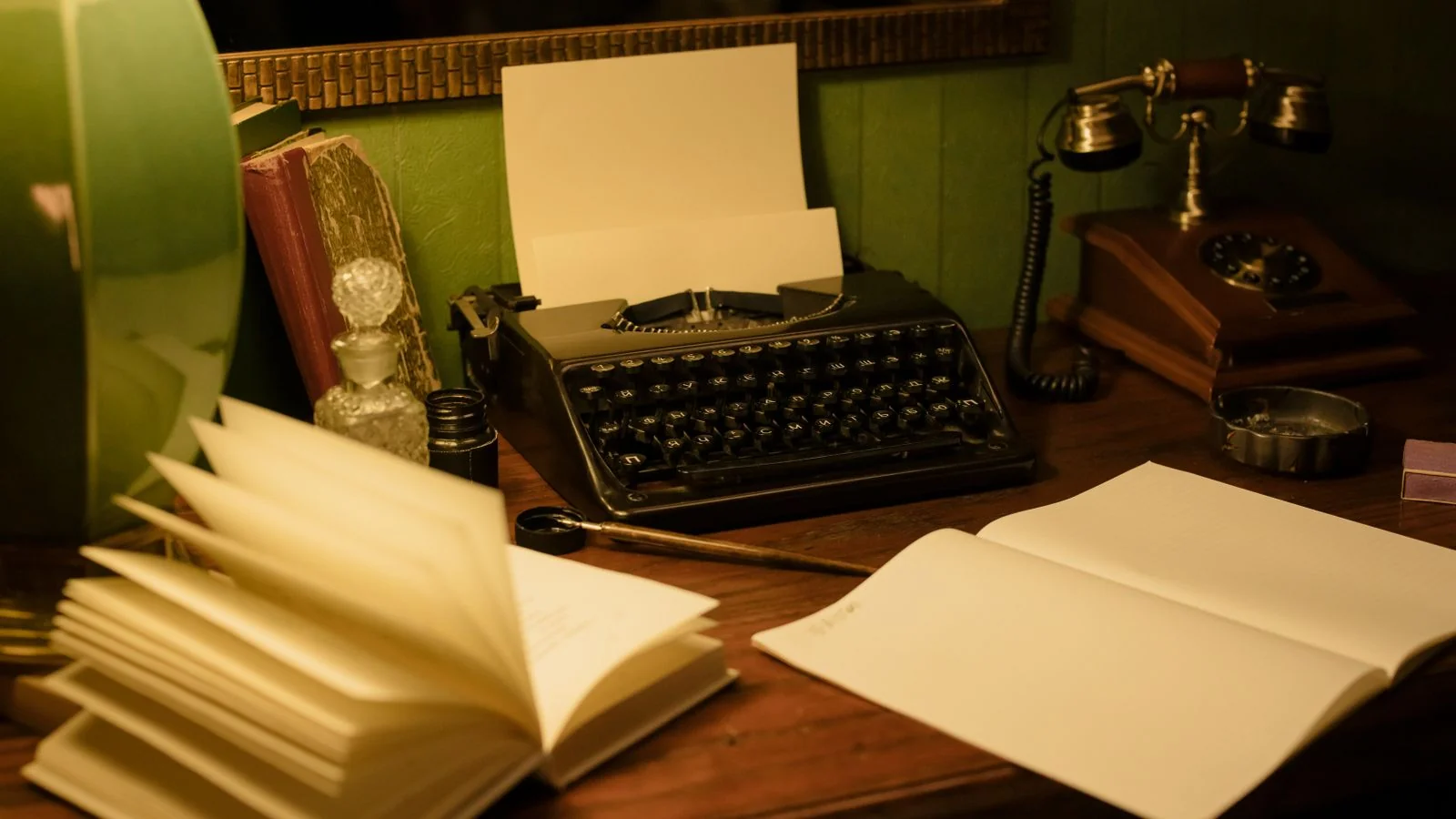 A vintage typewriter on a desk with books, a reminder that the format has not changed much