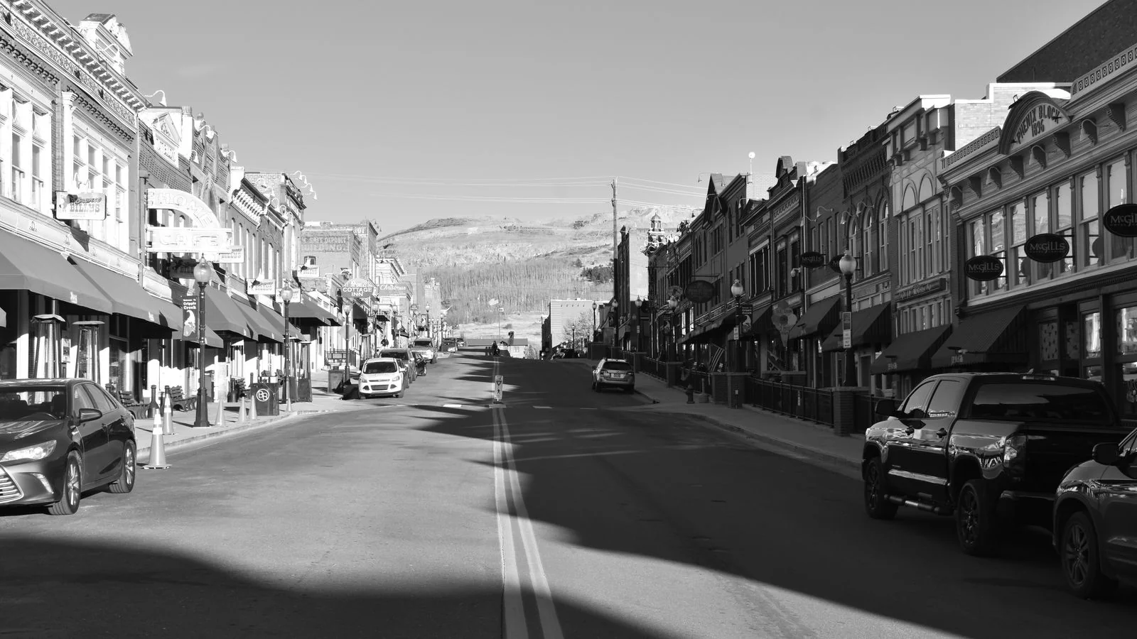 A historic main street in black and white, the local geography every regional story sits inside