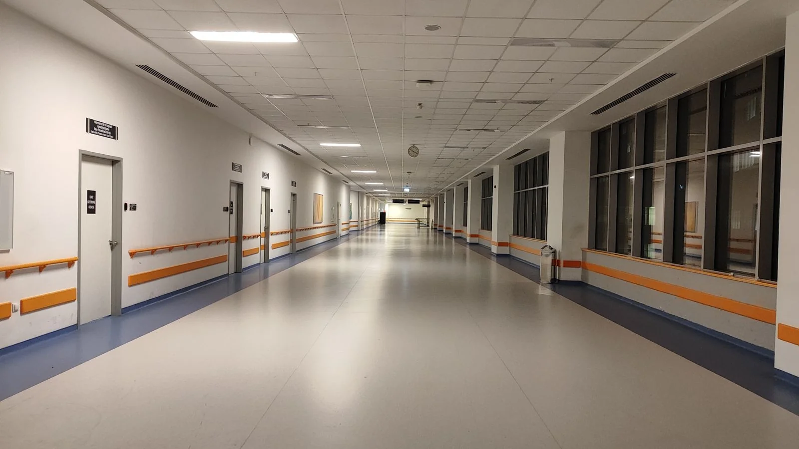 A bright, modern hospital corridor, the regulated environment every healthcare announcement operates within