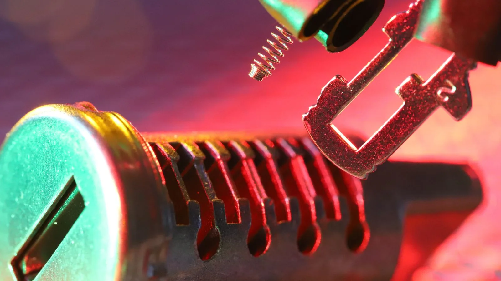 Macro shot of a mechanical lock cylinder and key showing the internal pin components.