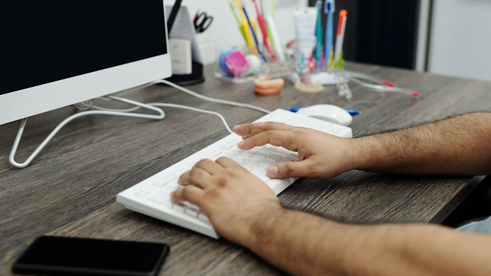 Hands typing at a keyboard in an office, the four hundred words that decide whether anyone calls back