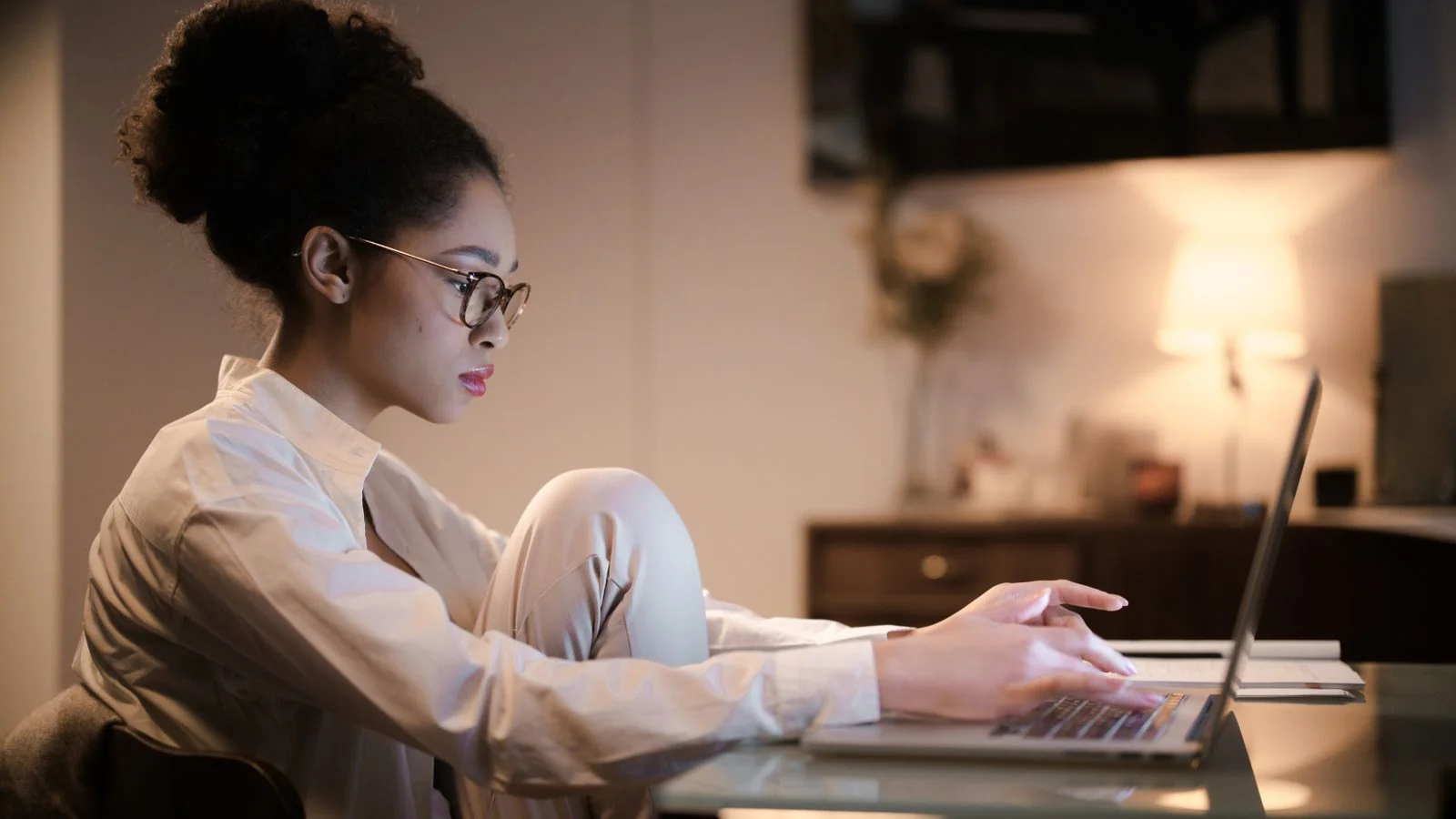 Close-up of hands typing a story on a laptop keyboard in a focused workspace.