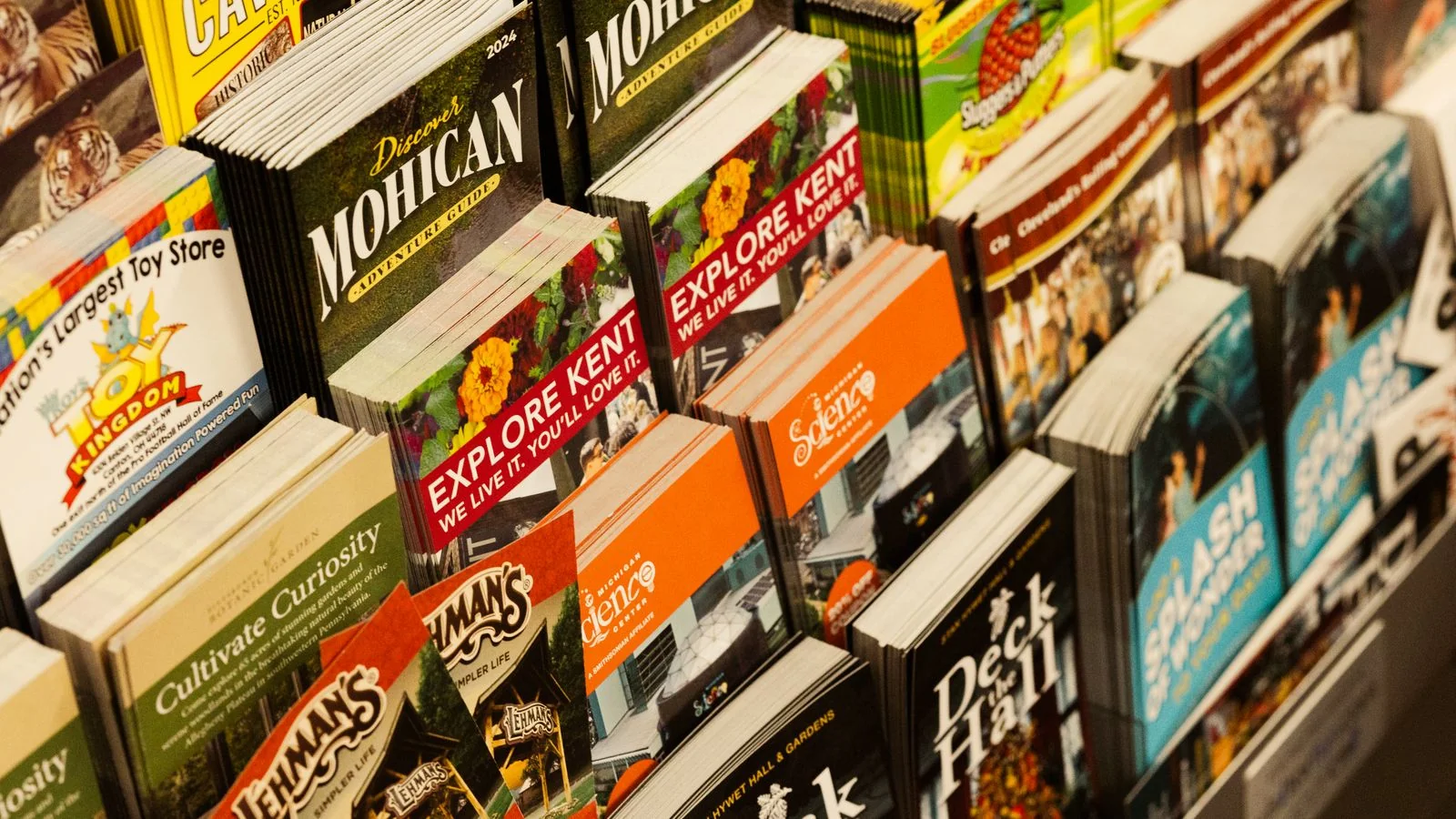 A rack of colorful printed brochures, the kind of work a local print shop produces.