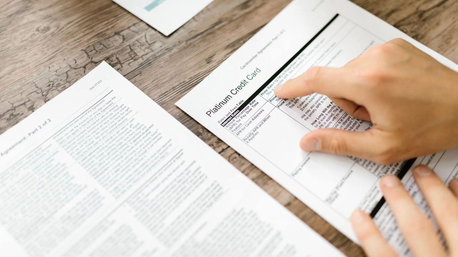 A stack of printed documents and a pen on a desk
