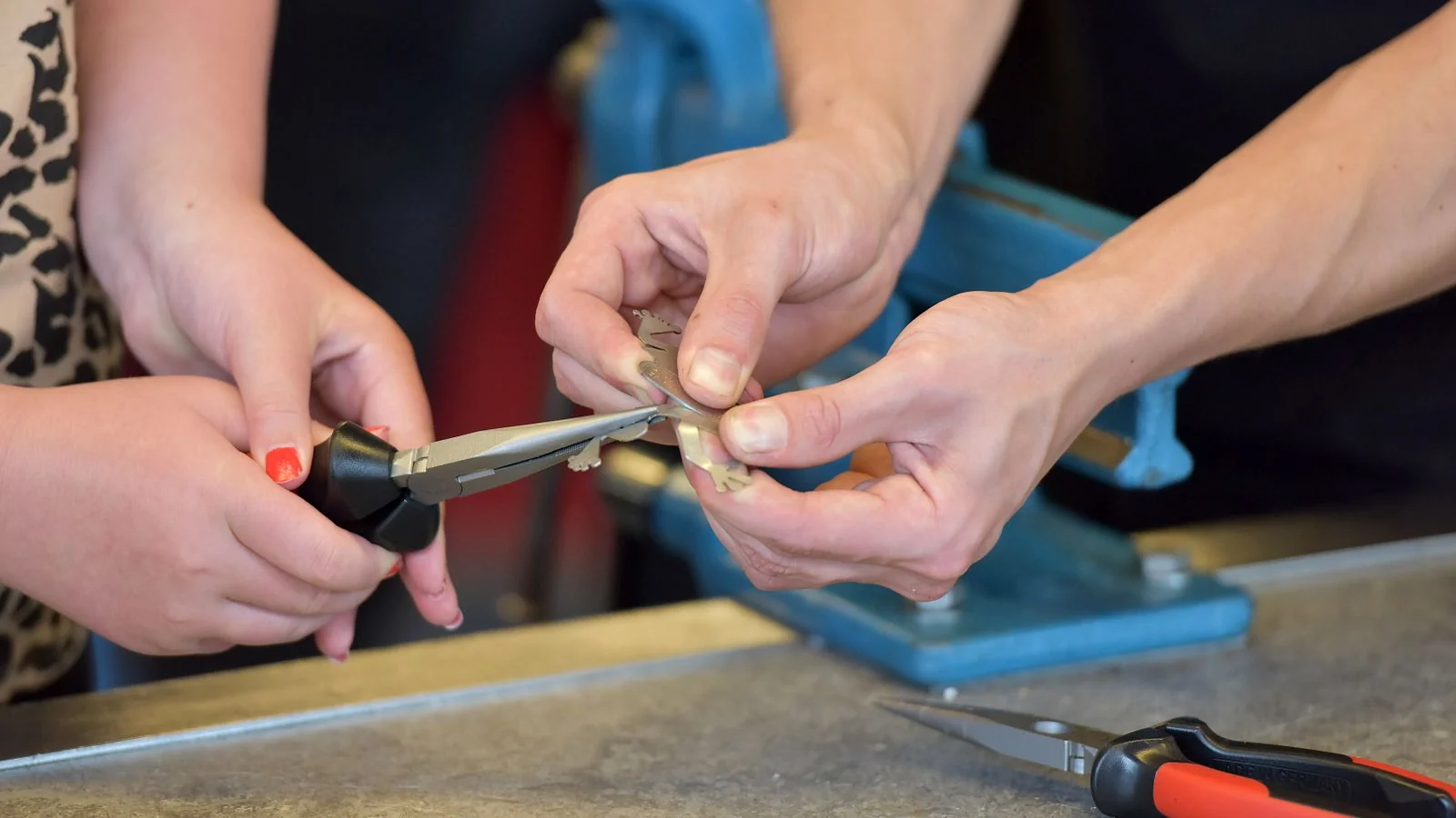 Hands using pliers at a workbench, the detail that makes a trade profile readable