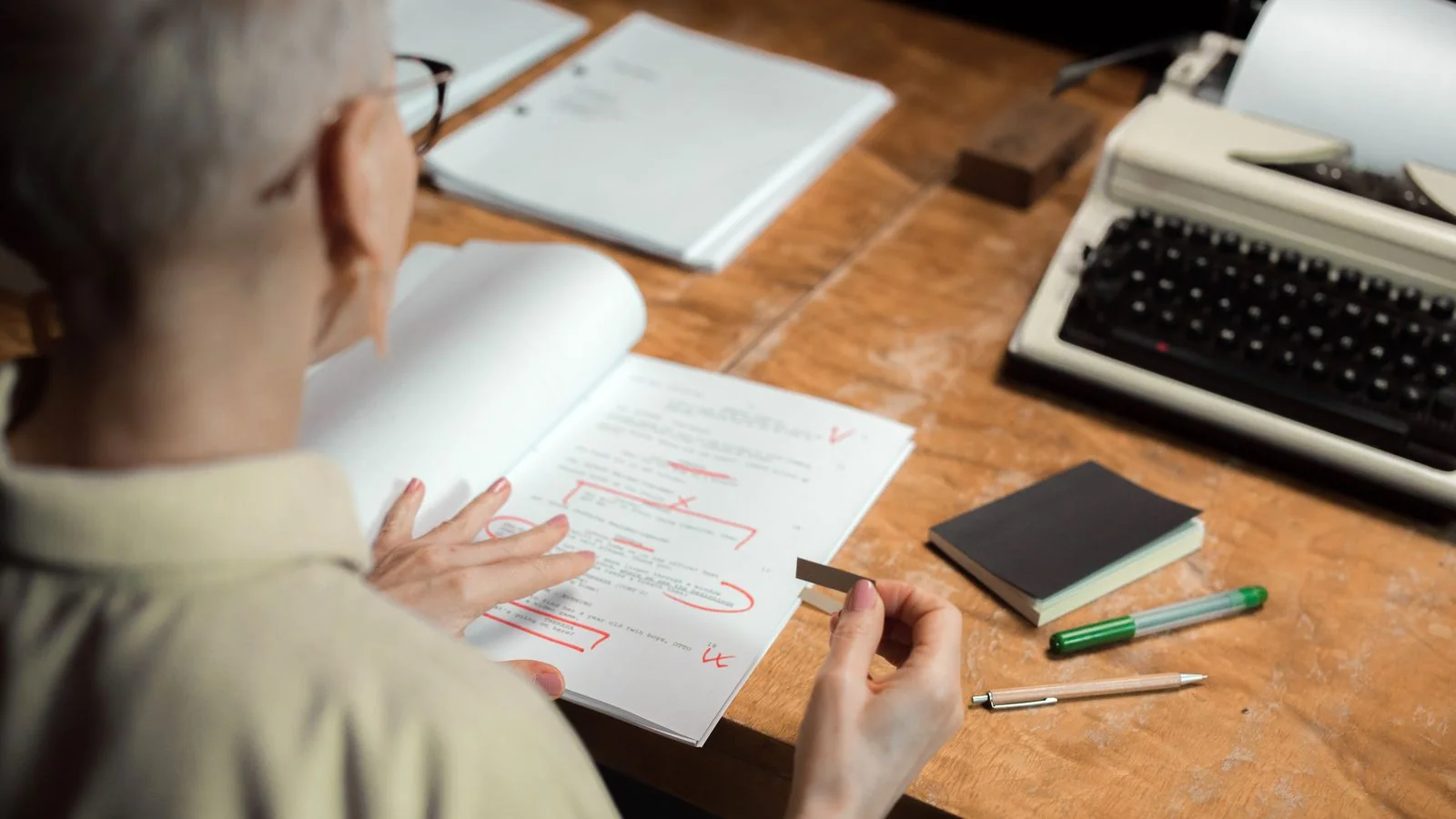 An editor marking up a printed draft, the revision pass that moves the answer to the top of each section