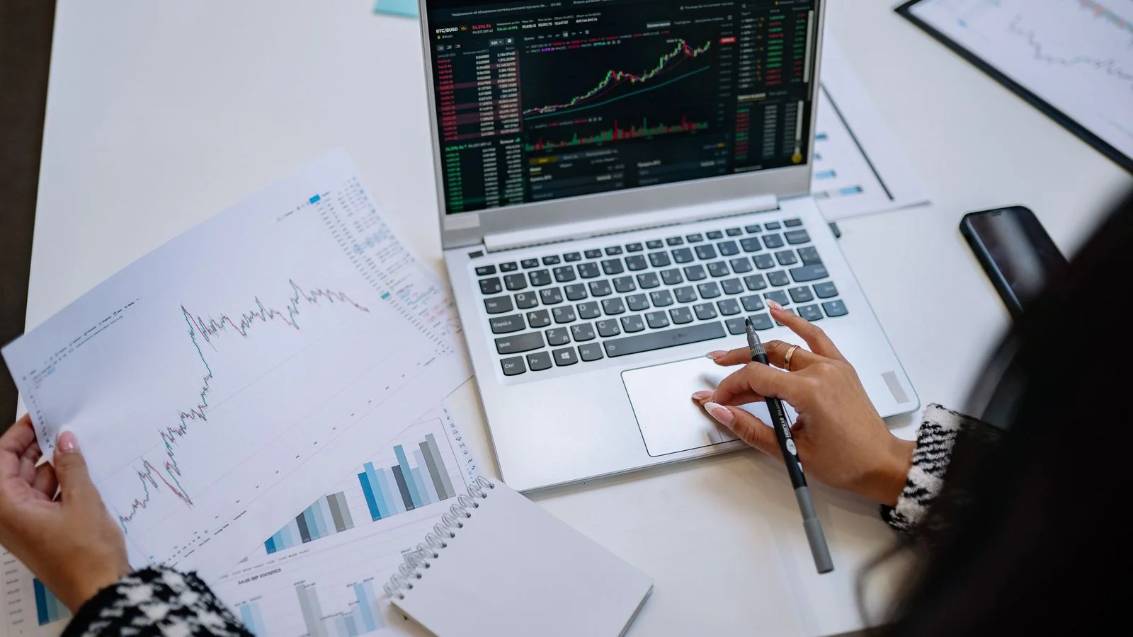 Laptop on a table displaying business analysis graphs and financial charts, the data that earns a citation