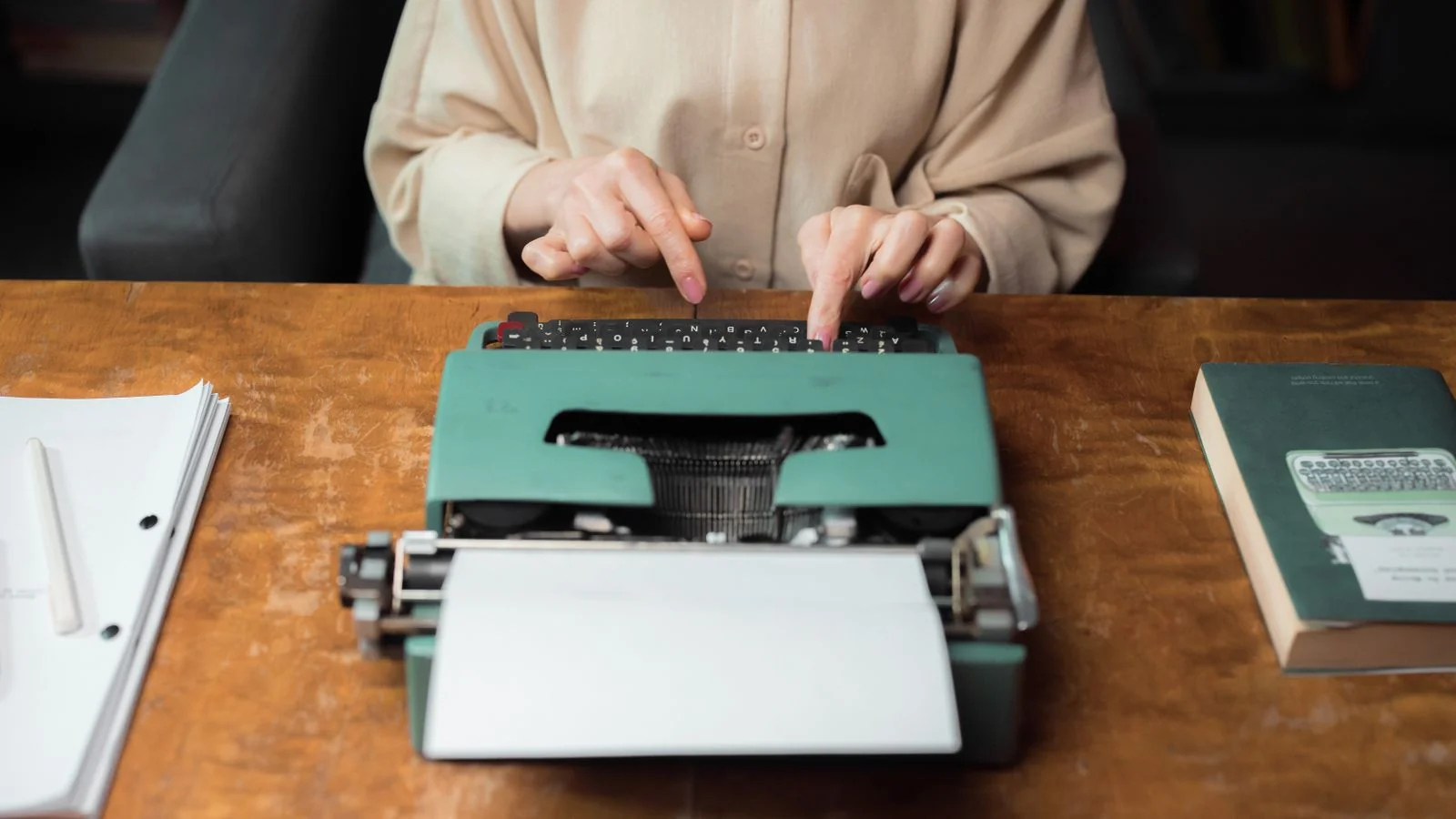 A person typing at a desk, sharpening an argument before sending a pitch.