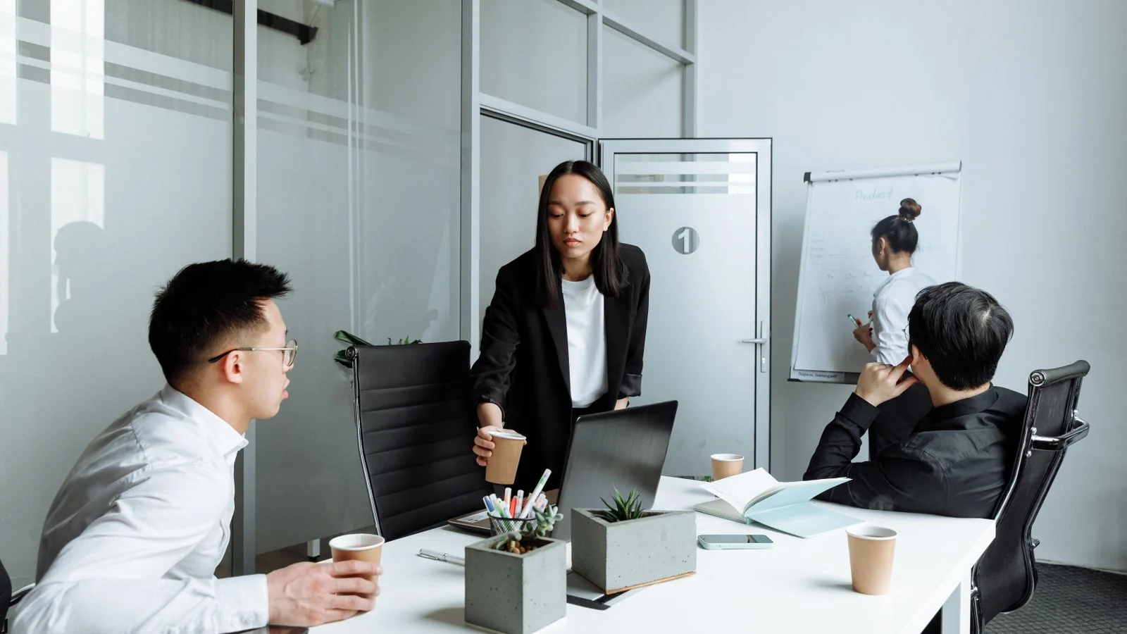 A team collaborating in an office, the coordinated work of building a consistent brand entity