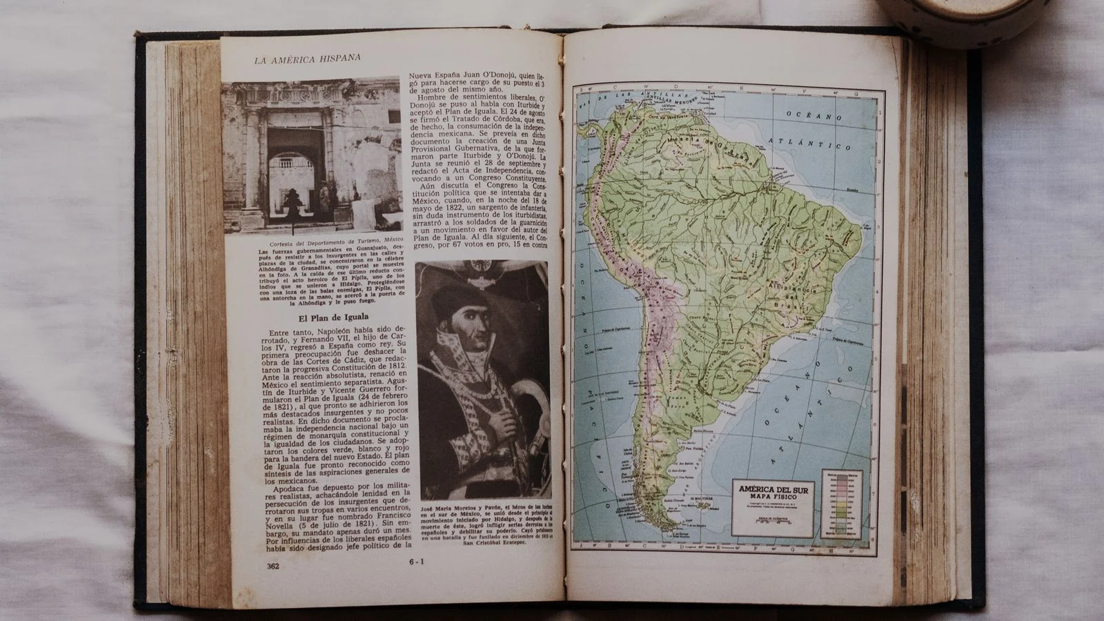 Open reference book with a map and dense text, the encyclopedia sources Google's panels depend on