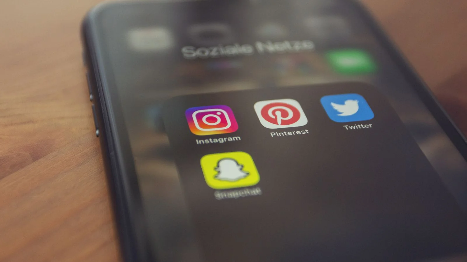 Social media apps clustered on a phone screen, the fast open network where X content spreads to strangers