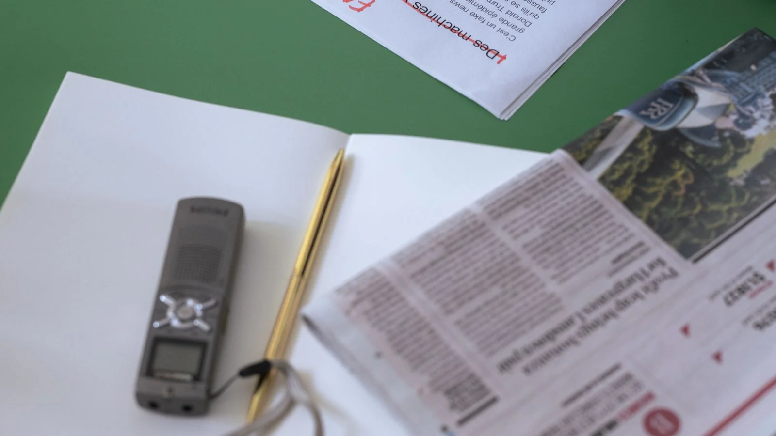 A person editing documents and written drafts at a desk