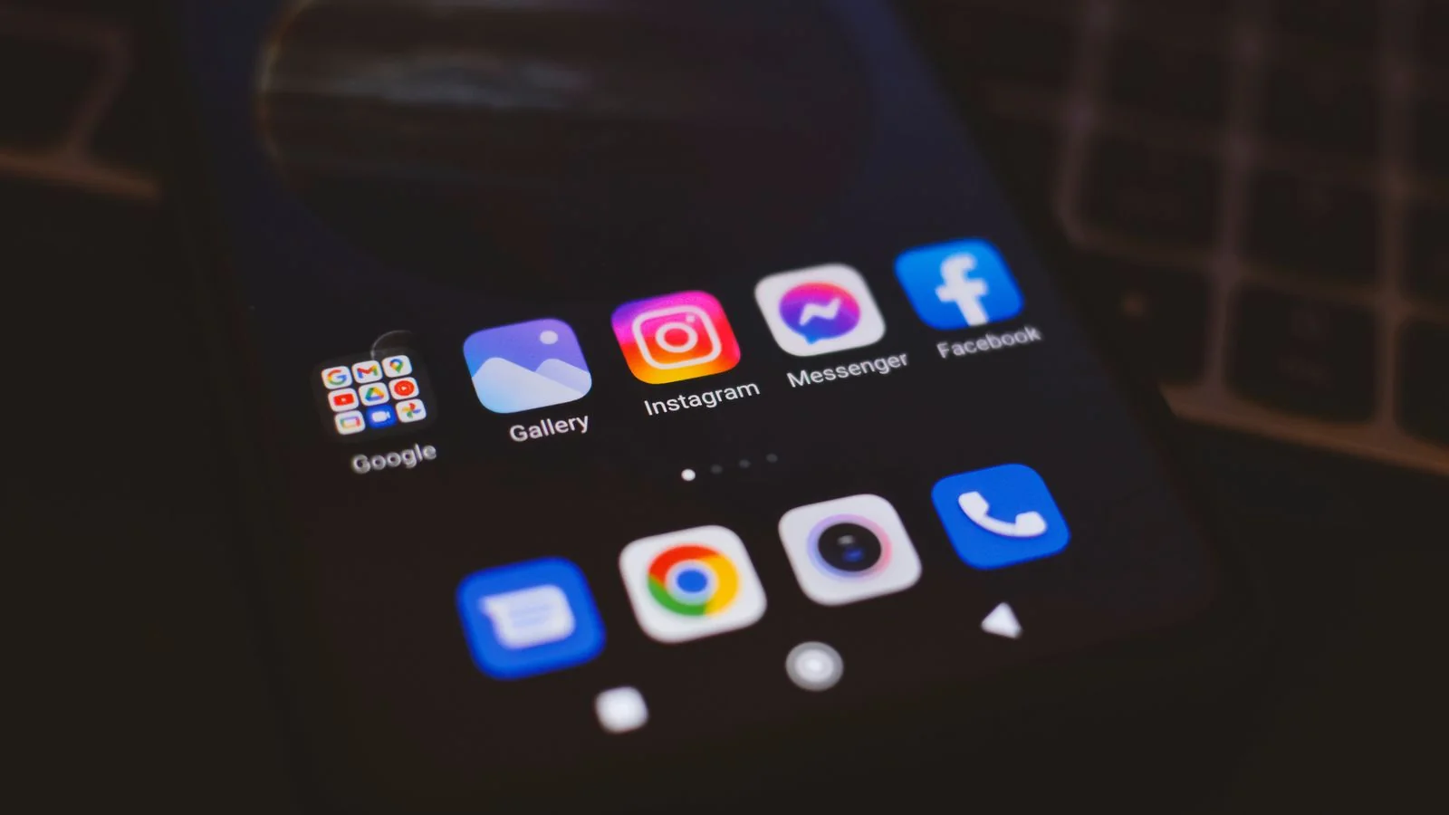 Smartphone showing social media apps in low light, the channels every tool in this list claims to monitor