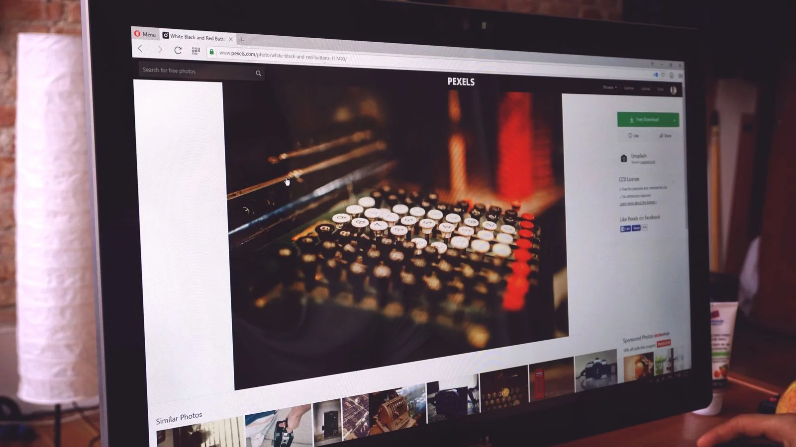 A monitor showing a typewriter image on a working desk, where journalist research happens now