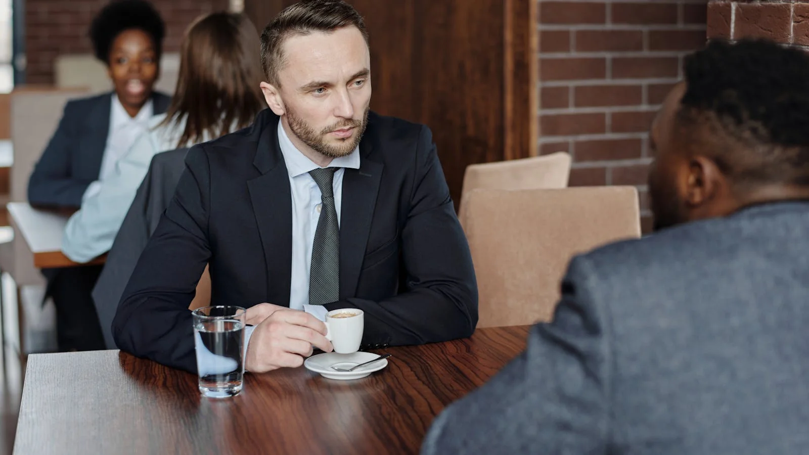 Two founders meeting over coffee, the quiet one-on-one that out-converts every cocktail-hour mixer