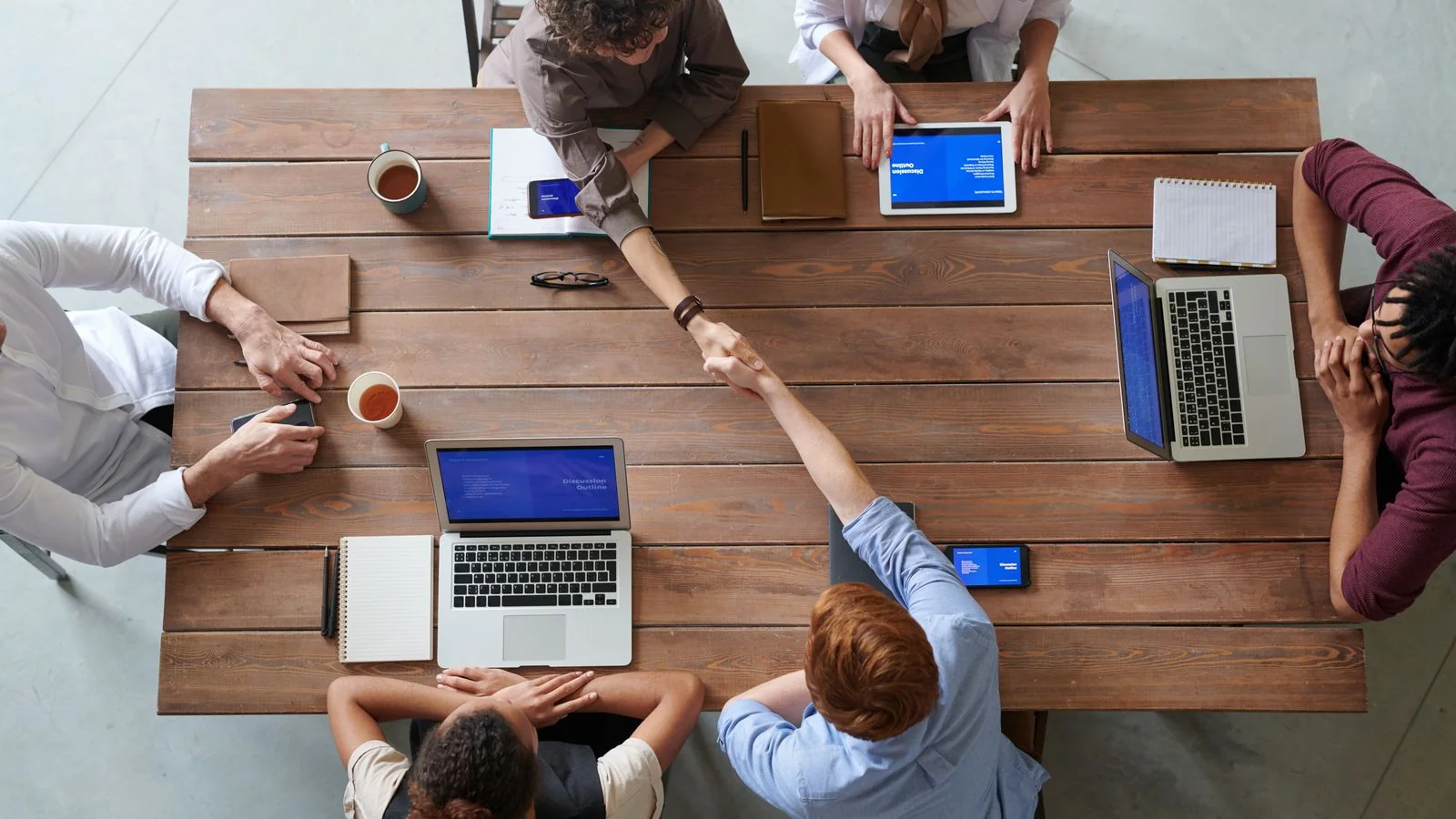 A team reviewing where a press release was republished across sites on a laptop
