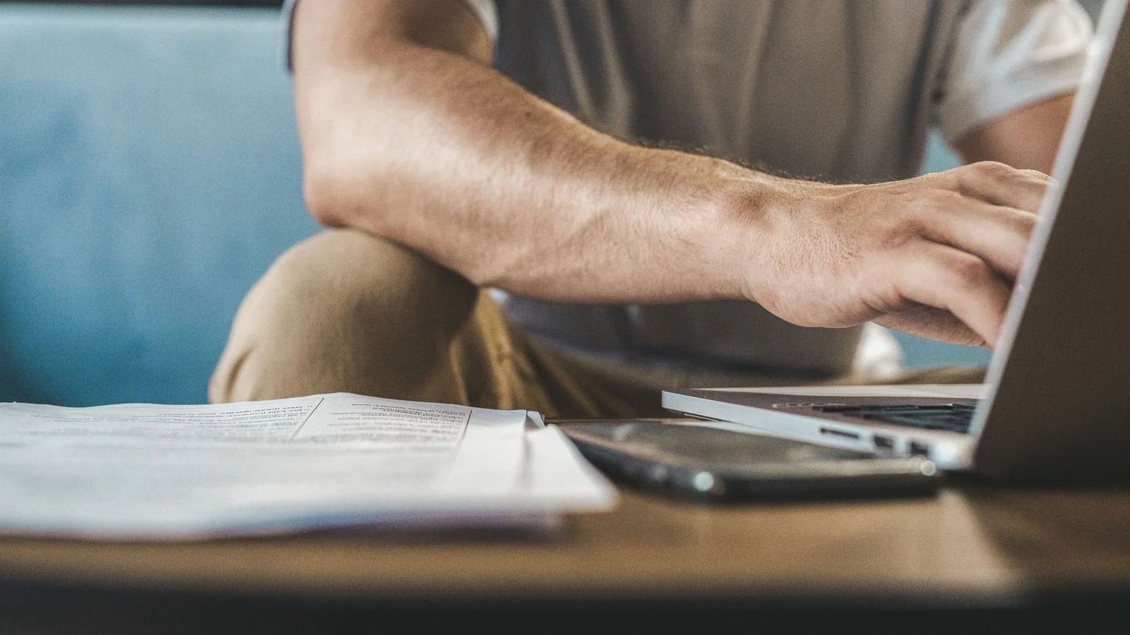 Person typing on a laptop at home, the kind of research session where a buyer reads through a business's reviews