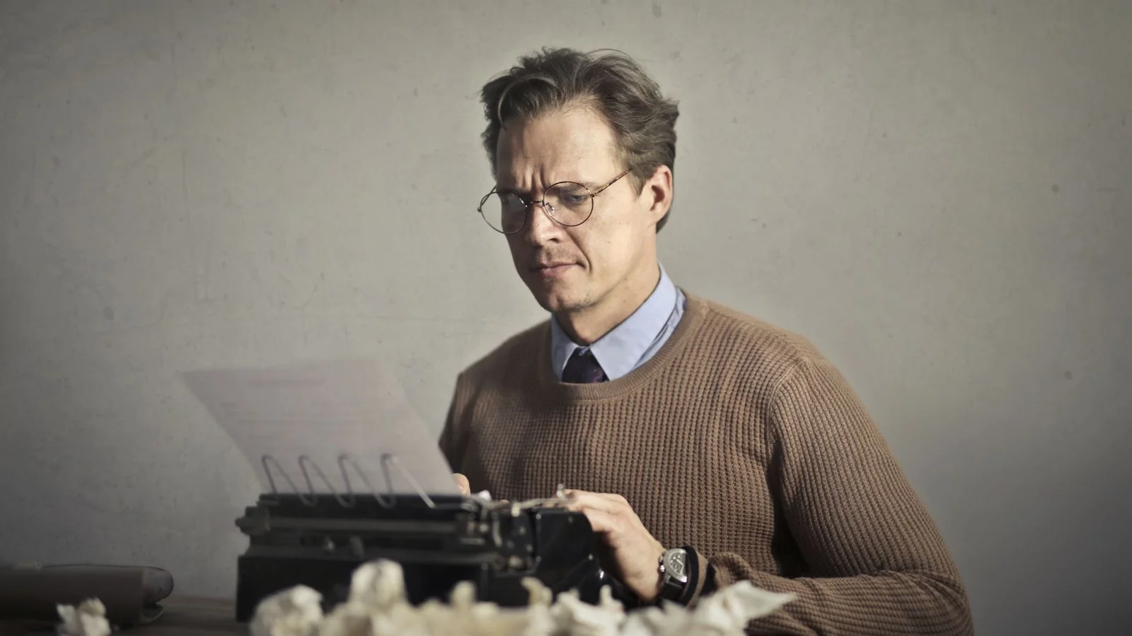A person reading a newspaper on a bench, the audience an op-ed argues to on the opinion pages