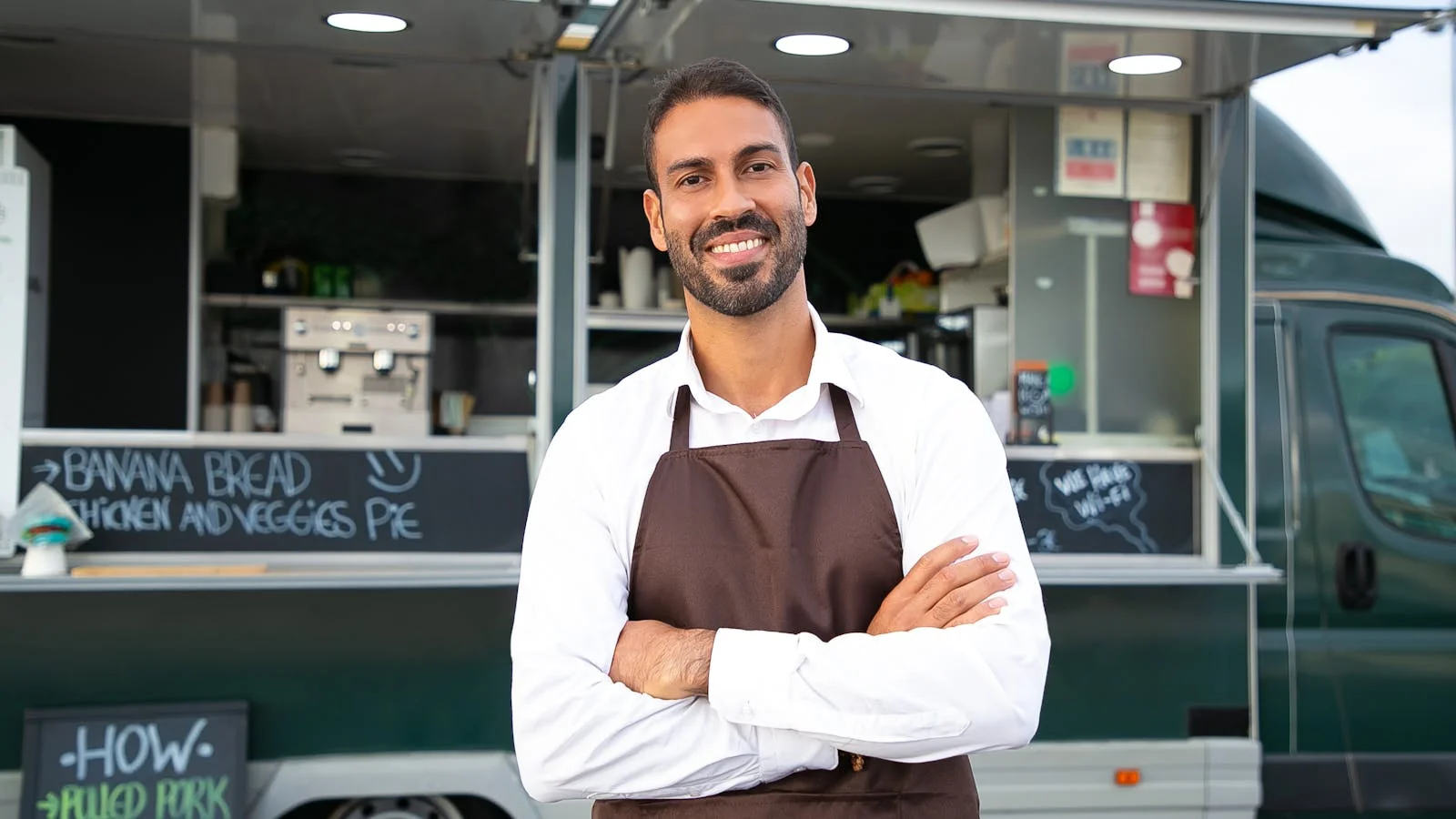 A barista at a counter smiling, the kind of named human whose testimonial carries more retrieval weight than a paragraph of marketing prose.