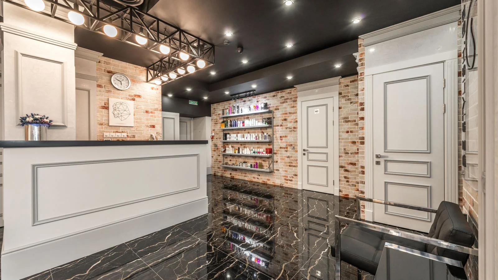 A clean salon reception counter with fresh flowers, the first impression a stranger forms before anyone speaks