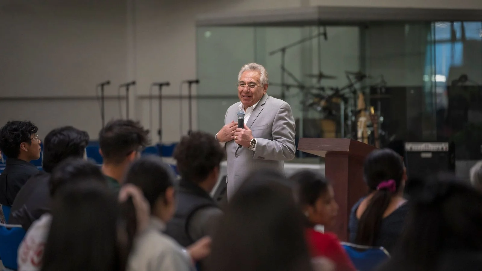 A speaker addressing a small audience at a training talk.