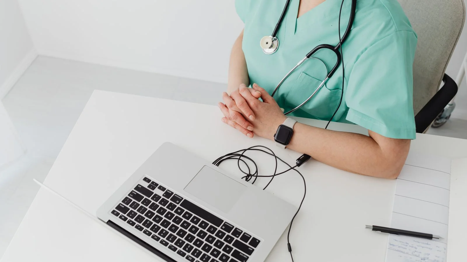 A clinician on a laptop consultation, the referral conversation most clinic owners are absent from