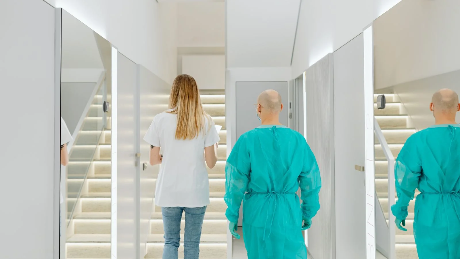 Two practitioners walking through a clinic corridor, the professional network that sends the highest-value clients