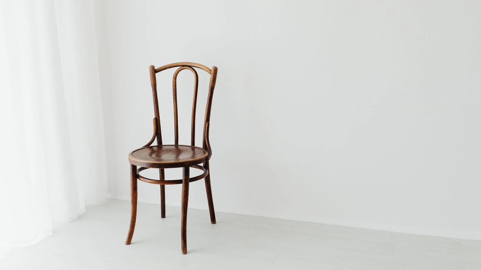 A single wooden chair in a bright empty room, the one client your claim should fit