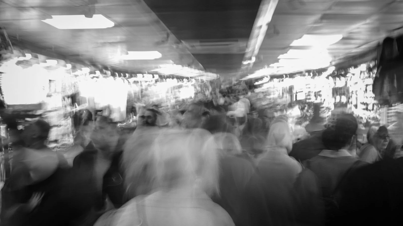 A blurred urban crowd in black and white, how undifferentiated positioning looks from the outside