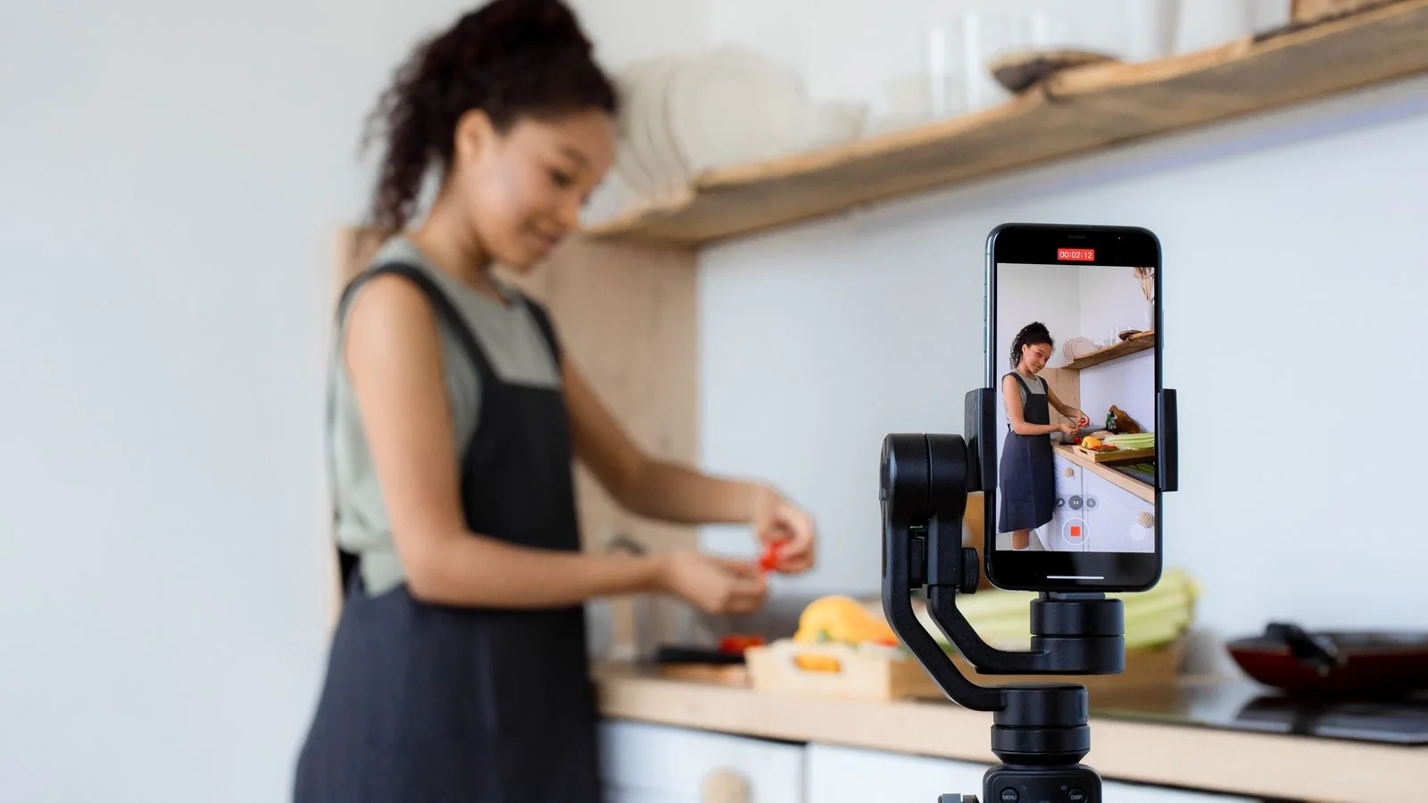 A person films a short how-to video on a smartphone while demonstrating a task.
