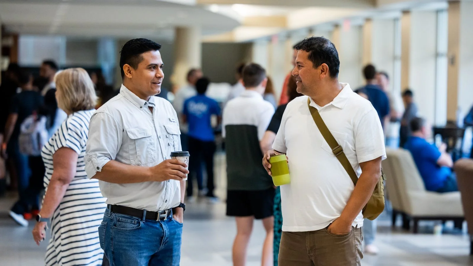 Two real estate professionals talking at a networking event, where title company names get made.